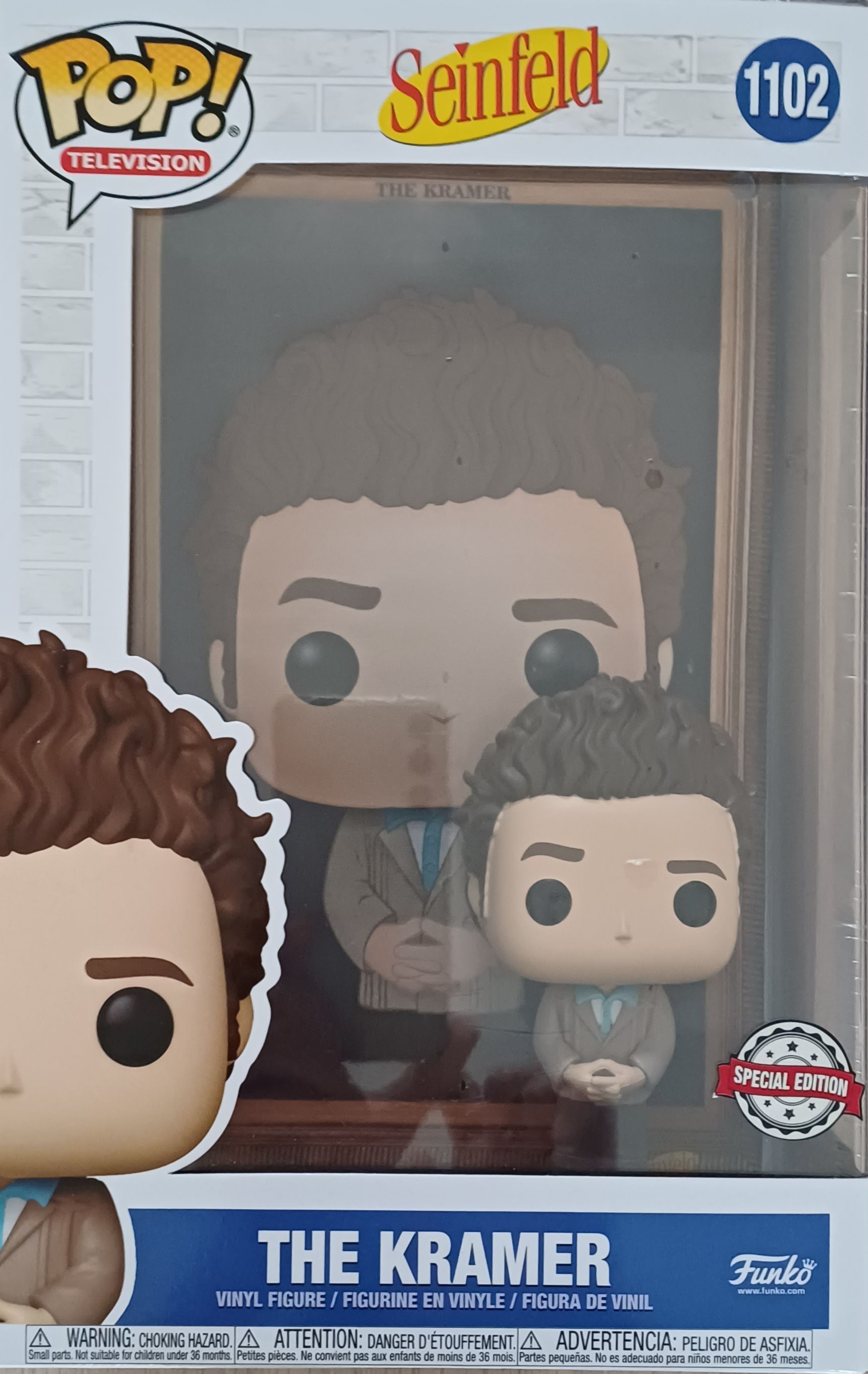 Funko Pop! Kramer uit Seinfeld, figuurtje in doos. Bruin haar, beige pak en lichtblauwe stropdas.