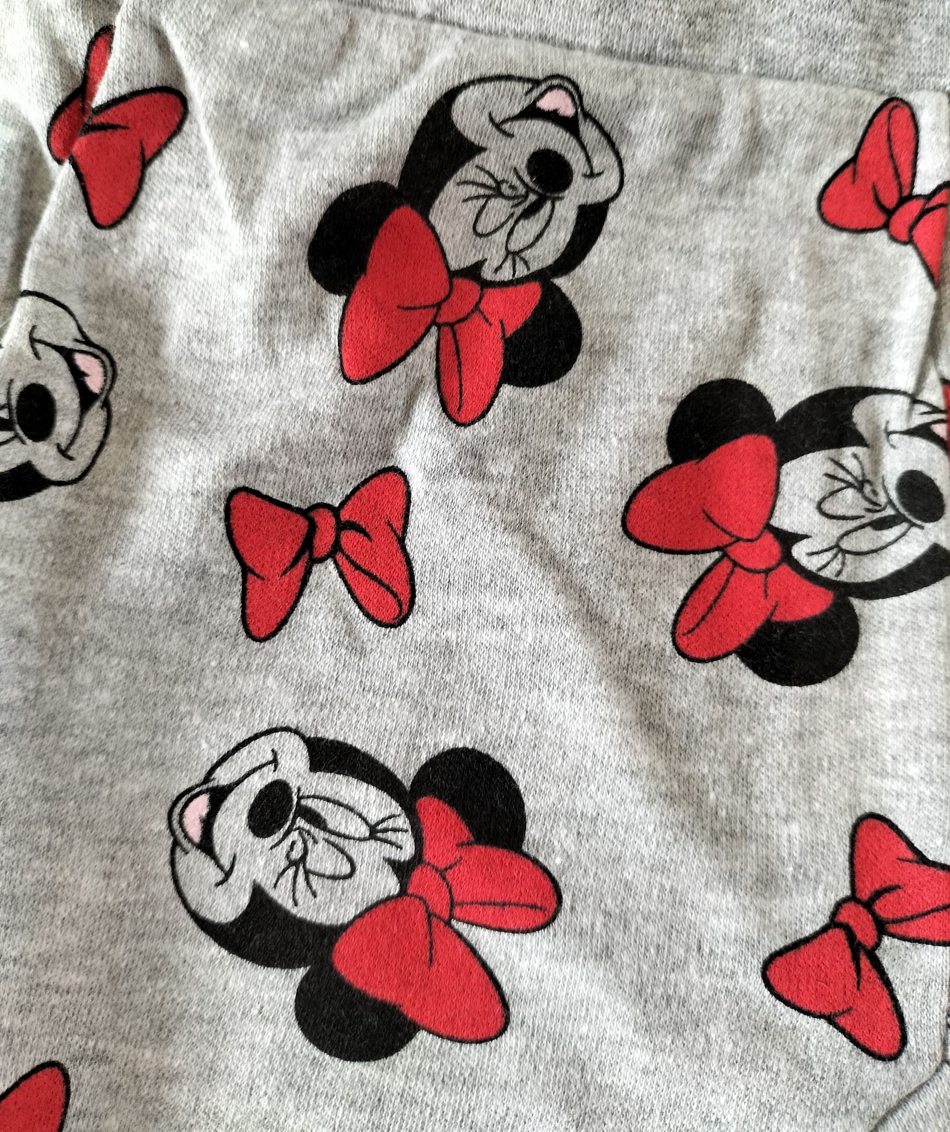 Grijze babybroek met rode Minnie Mouse-print en strikjes.