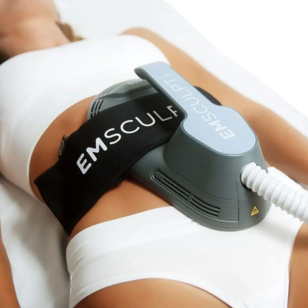 EMSculpt body contouring device on a person’s abdomen with black and gray applicator straps