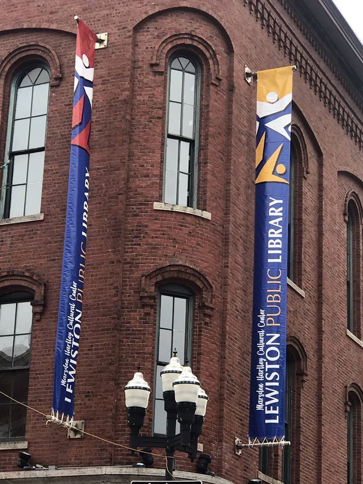A brick building with a blue banner that says lewiston public library