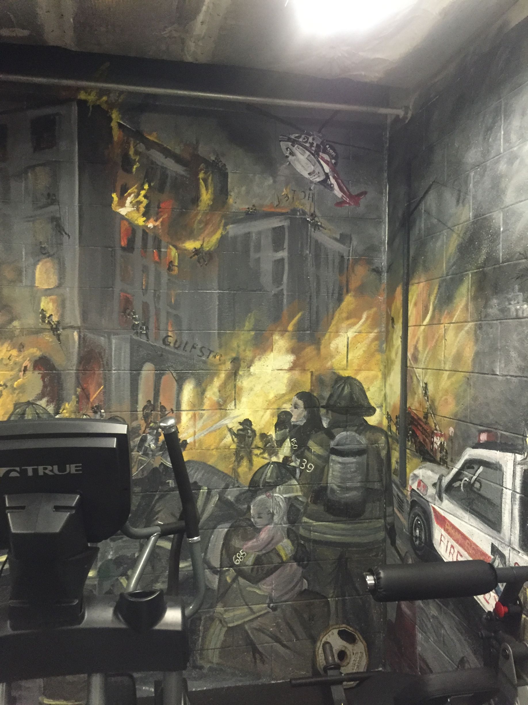 Soldiers in a burning, war-torn room, seen through a rifle sight in a video game screenshot