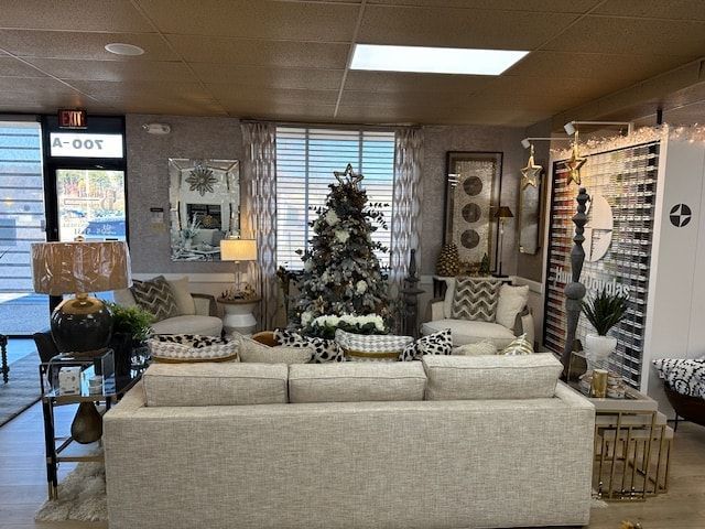 Living room display with sofa, decorated Christmas tree, and decorative items.