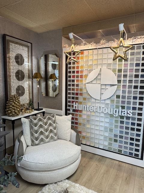 Interior with Hunter Douglas display, cream swivel chair, decorative accents, and color samples.
