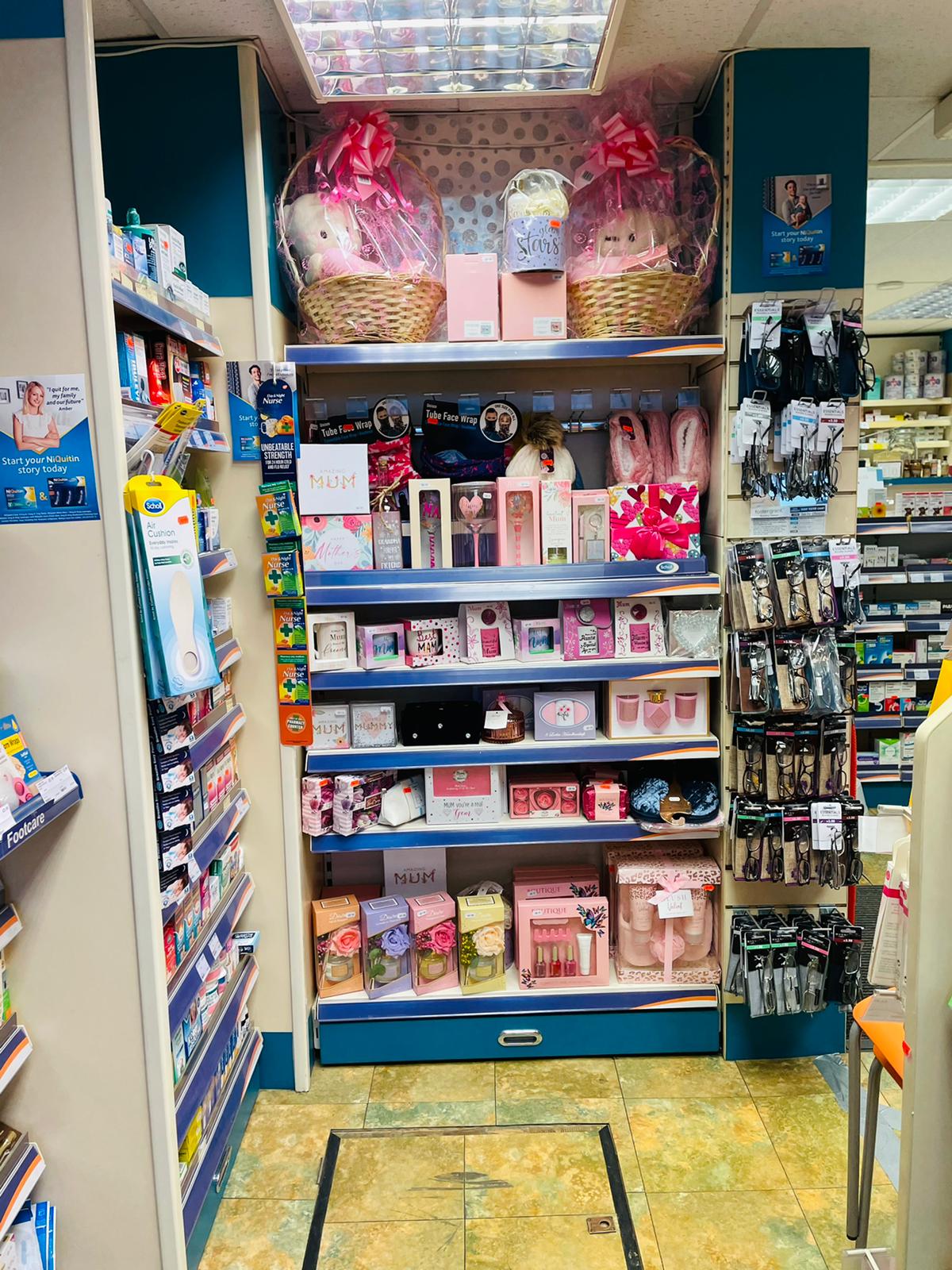 Interior view of Ramzy's Pharmacy showing shelves stocked with health and beauty products, gift baskets, and pharmacy items.