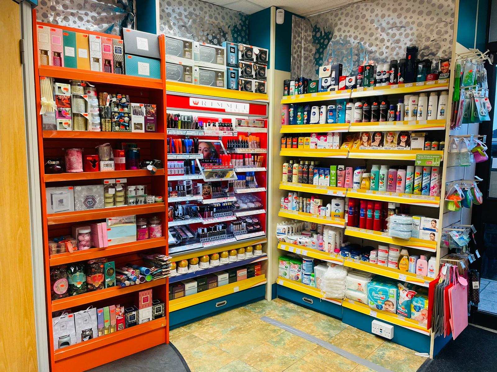 Aisle view inside Ramzy's Pharmacy featuring shelves filled with health supplements, personal care items, and vitamins