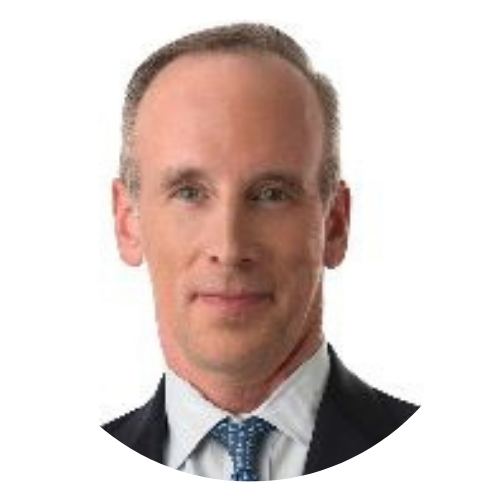 Head-and-shoulders portrait of a man in a dark suit, white shirt, and blue tie on a white background