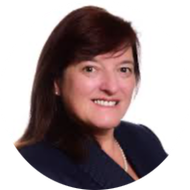 Smiling woman in a dark blazer against a white background