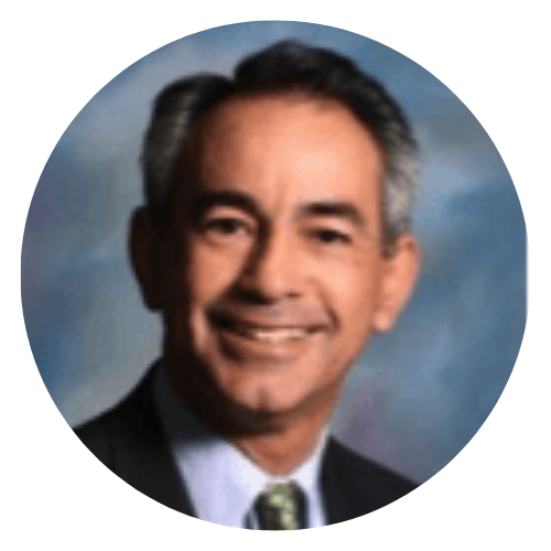 Portrait of a smiling man in a suit and tie against a blue studio background