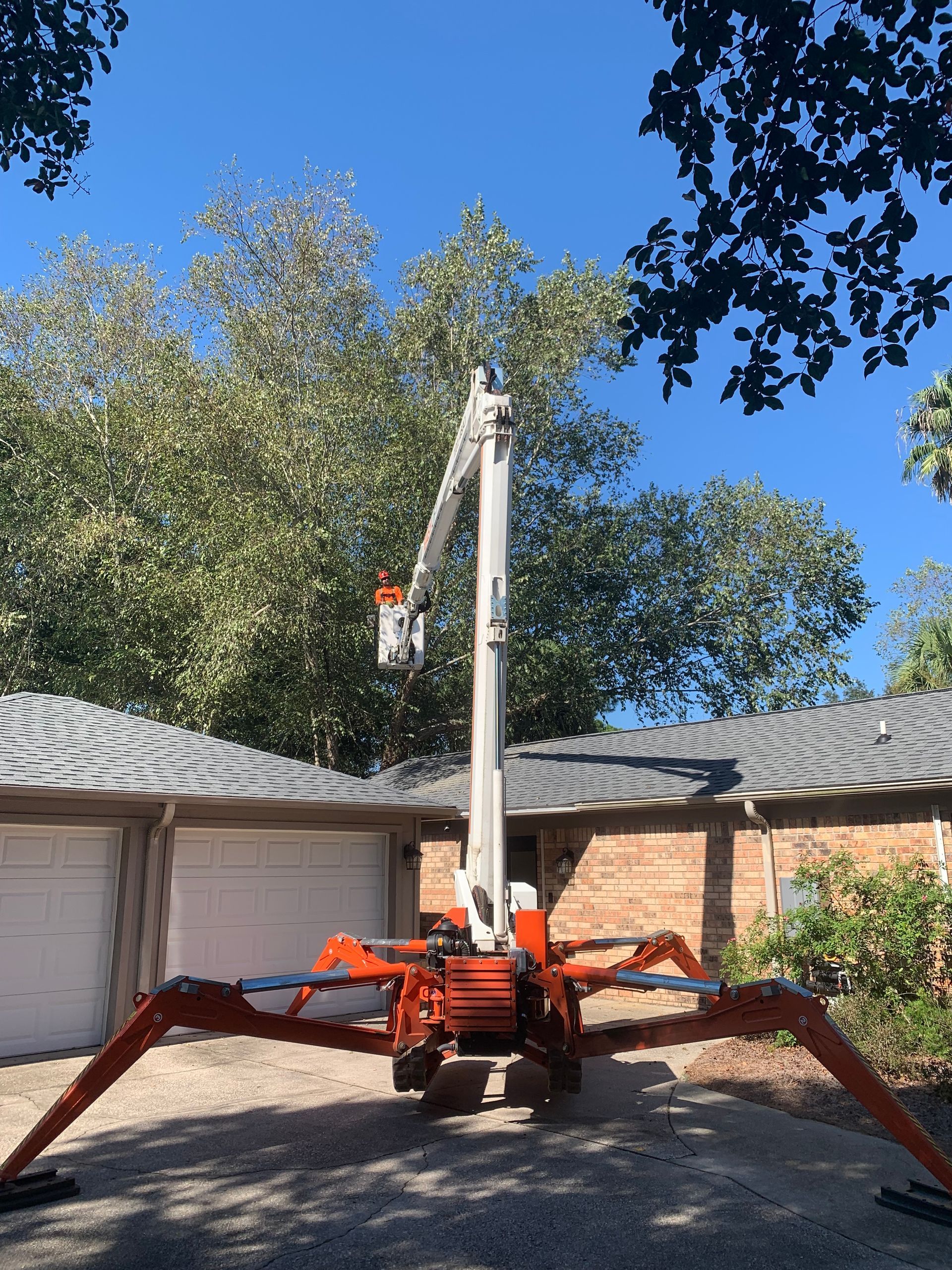 A crane is sitting in front of a house.