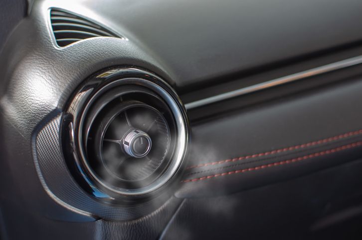 a close up of a car air vent with air conditioning coming out of it .