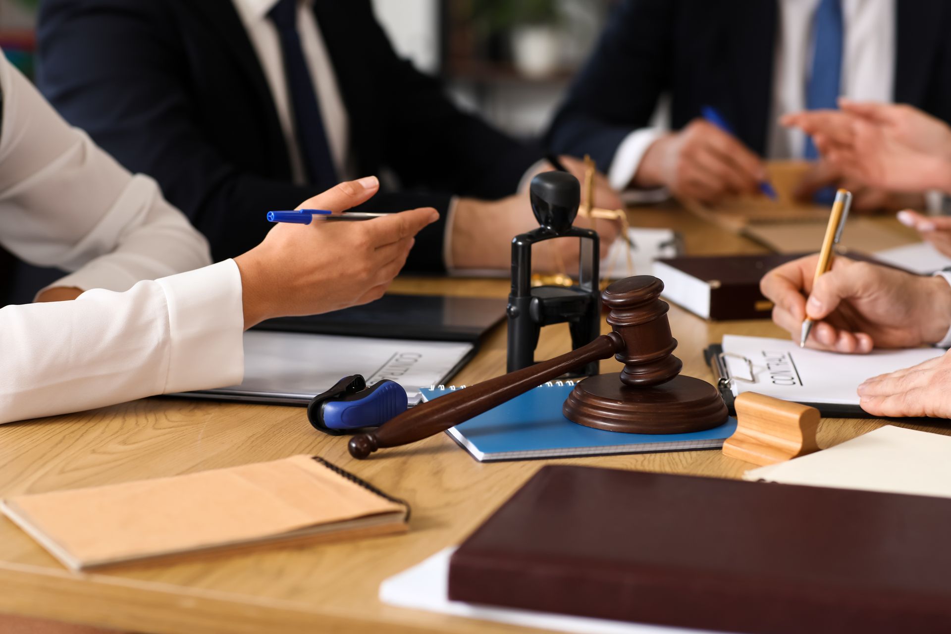 Criminal attorney reviewing legal documents with a gavel during a client consultation