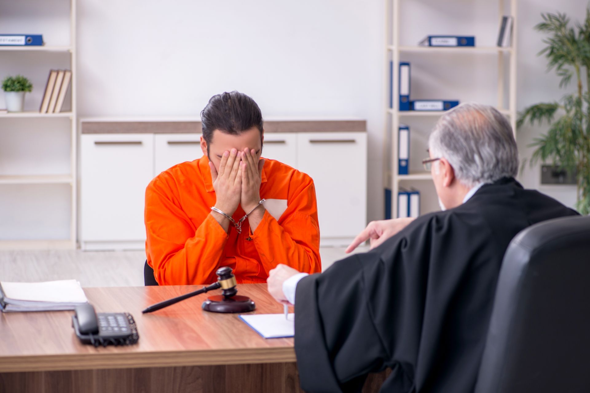 Criminal Defense Attorney meeting with a client to review arrest paperwork.