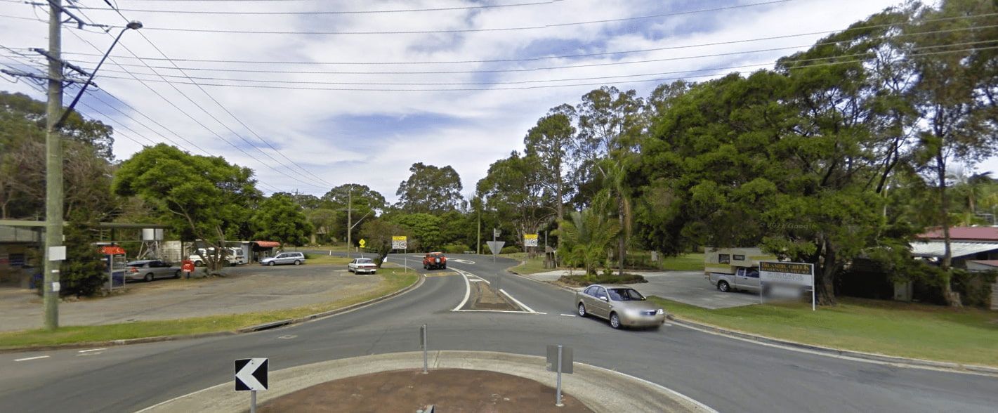 A Car Is Driving Through a Roundabout on A Residential Street — Murwillumbah District Plumbing Service in Bilambil, NSW