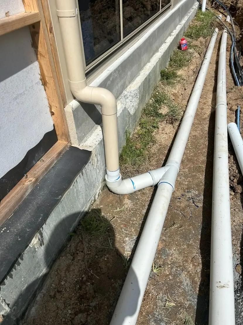 A Bunch of White Pipes Are Connected to A Wall — Murwillumbah District Plumbing Service in Nunderi, NSW