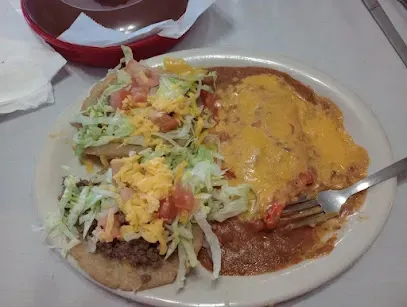 A plate of food with a fork in it on a table.