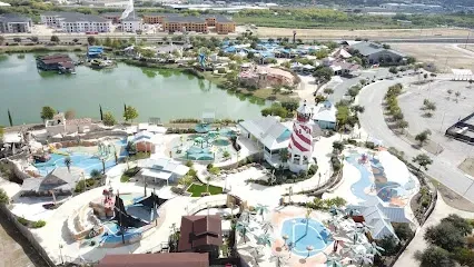 An aerial view of a water park with a lighthouse in the middle of it.