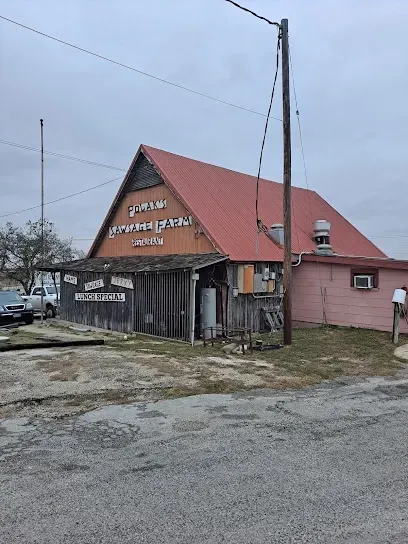 A building with a red roof and a pink building in the background