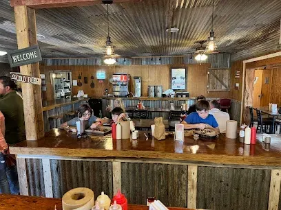 A group of people are sitting at tables in a restaurant.