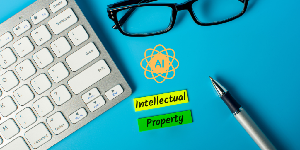 A keyboard , pen , glasses and a sticker that says `` intellectual property '' on a blue surface.