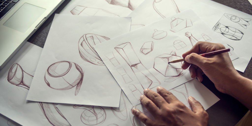 A person is drawing on a piece of paper with a pencil.