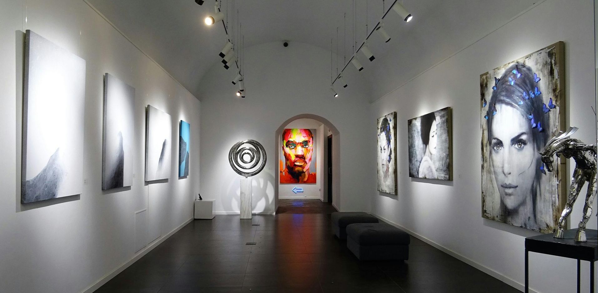 A long hallway with a lot of paintings on the wall