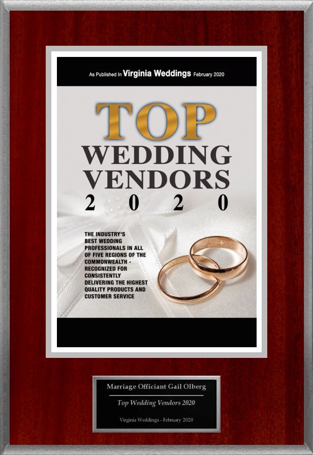 Framed “Top Wedding Vendors 2020” magazine cover with gold rings on a red wooden plaque