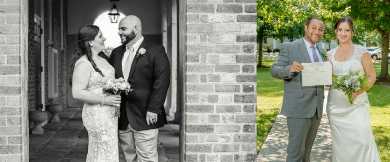 Wedding couple posing outdoors, holding bouquet and certificate in front of a brick wall