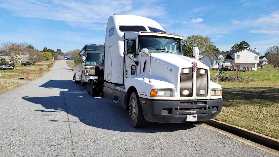 A white semi truck is driving down a road A white semi truck is driving down a road