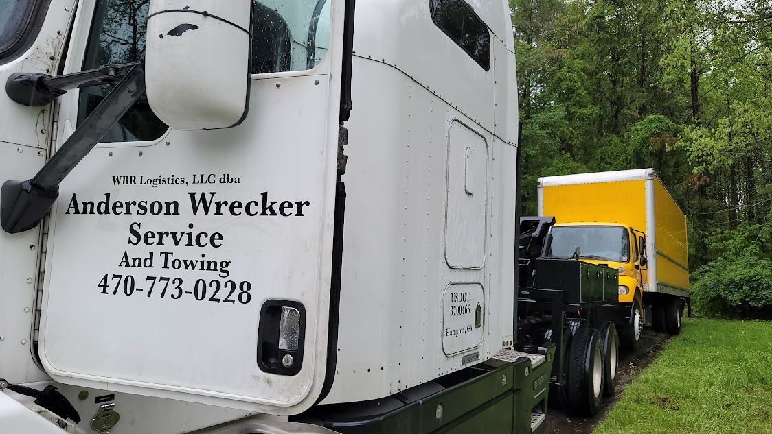 A white semi truck is parked next to a yellow semi truck.