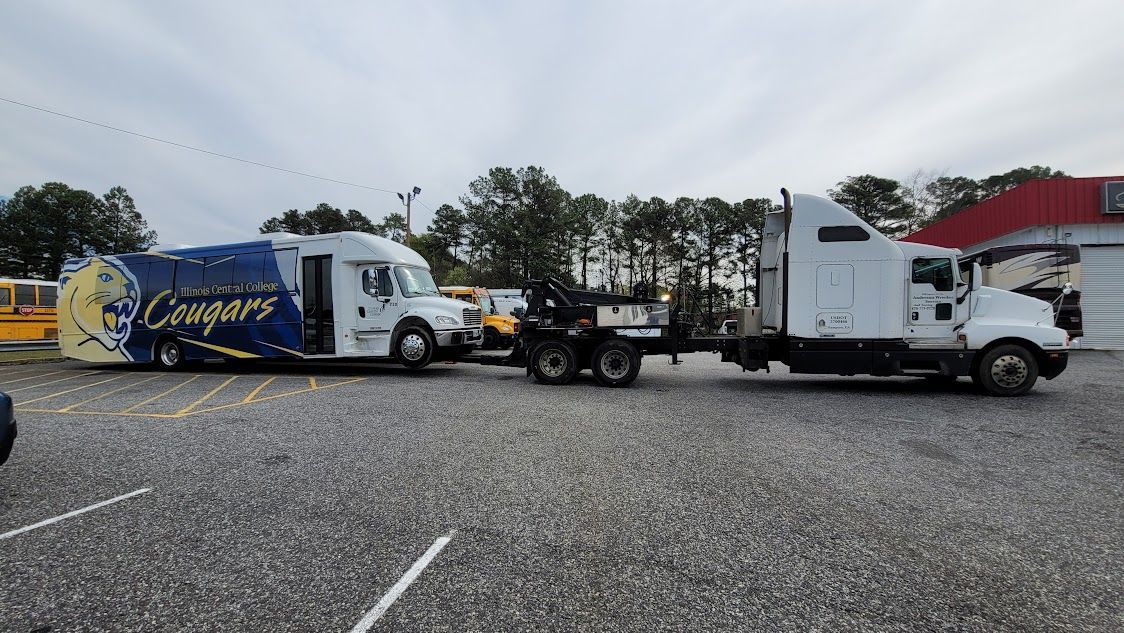 Two semi trucks are parked next to each other in a parking lot. Two semi trucks are parked next to each other in a parking lot.