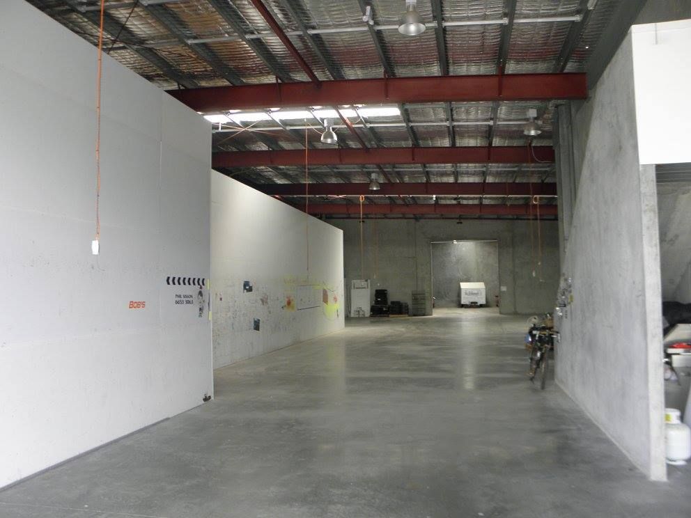 A Large Empty Warehouse With a Red Ceiling — North Coast Storage in North Boambee Valley, NSW