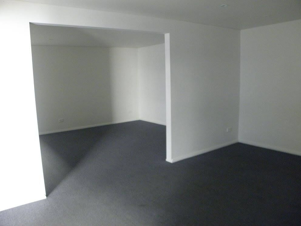An Empty Room With a Black Carpet and White Walls — North Coast Storage in North Boambee Valley, NSW