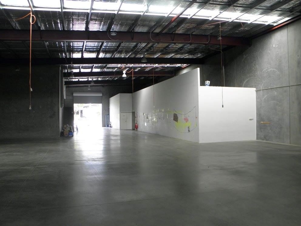 An Empty Warehouse With a Concrete Floor and White Walls — North Coast Storage in North Boambee Valley, NSW