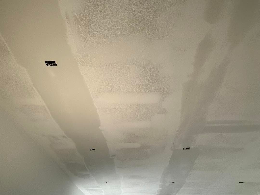 Ceiling under renovation with taped drywall seams and several recessed light openings