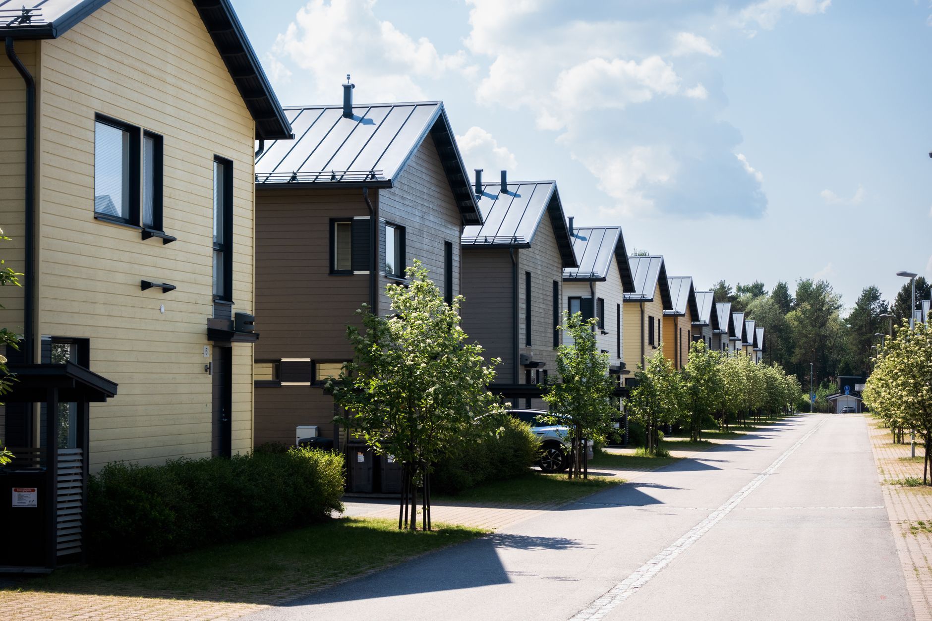Row of modern townhomes along a quiet street