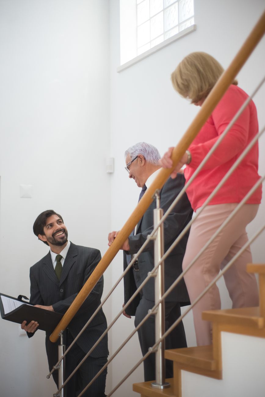 Older couple being shown through a home by a guide