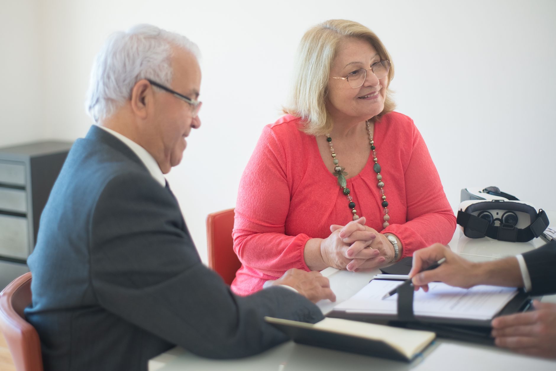 Older couple reviewing documents with an advisor