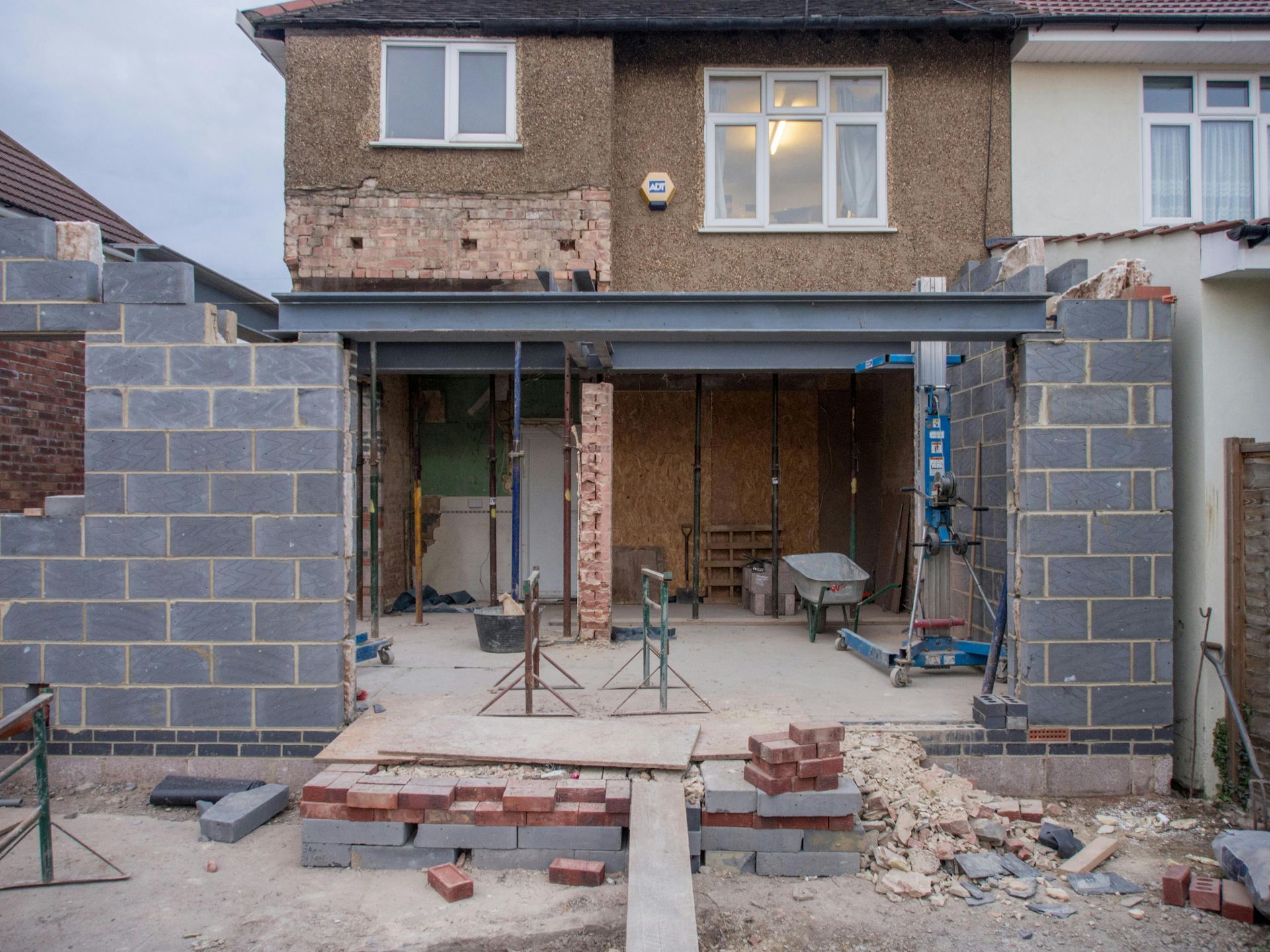 A house is being built with bricks and a metal structure.