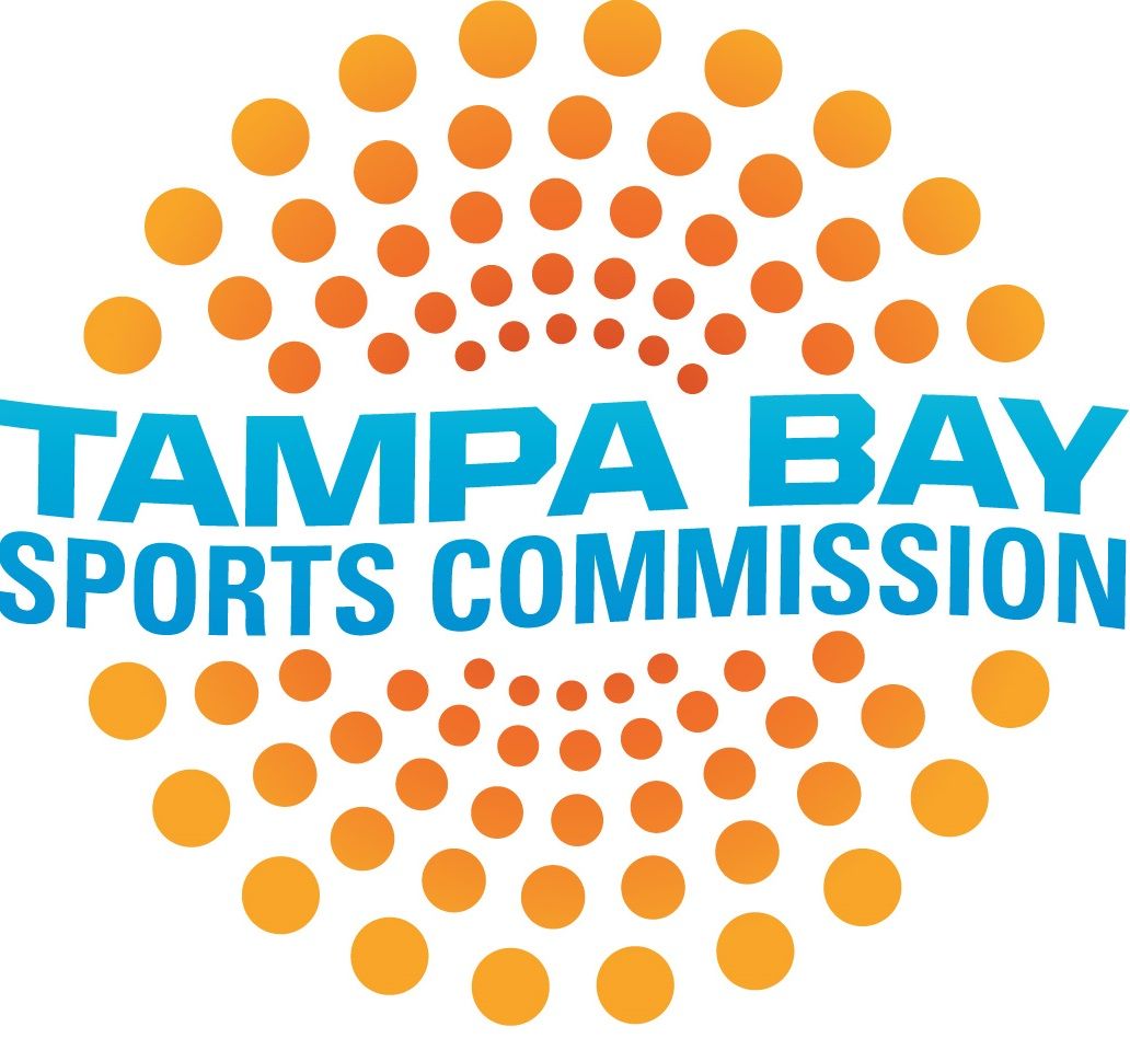 Tampa Bay Sports Commission logo with blue text and orange dot sunburst