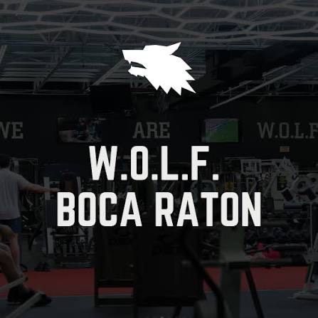W.O.L.F. Boca Raton gym interior with bold white logo over workout equipment and red flooring