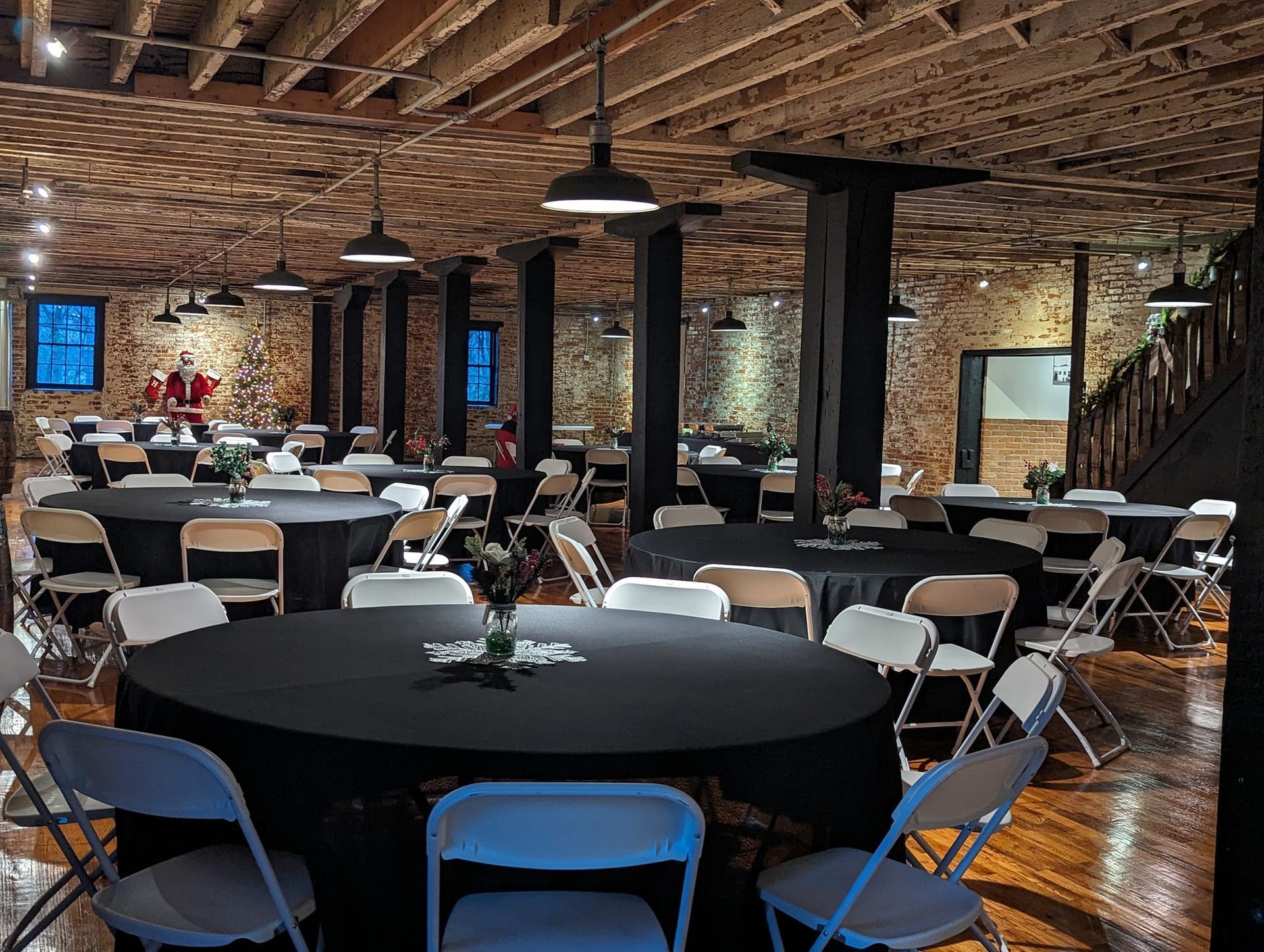 A large room with tables and chairs set up for a party