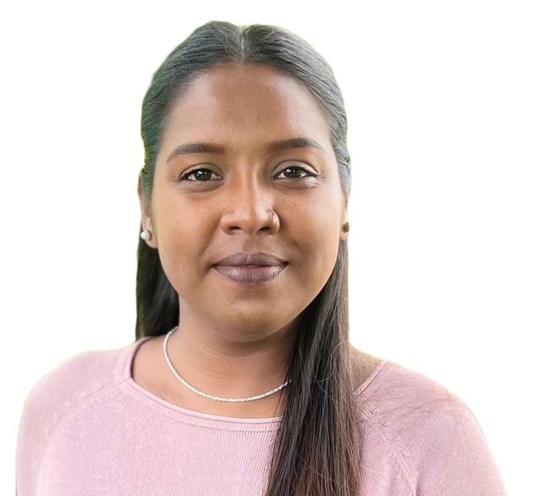 Portrait of a person with long dark hair wearing a pink top against a white background
