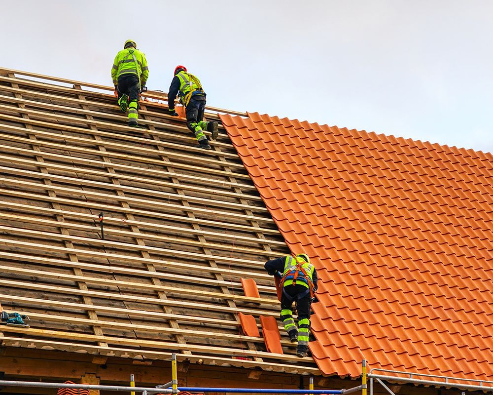 Three roofers from Meissen & Sons Roofing in a Roofing Replacement in Raymore, MO