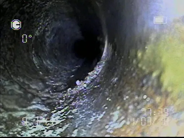 A close up of a pipe with water coming out of it.