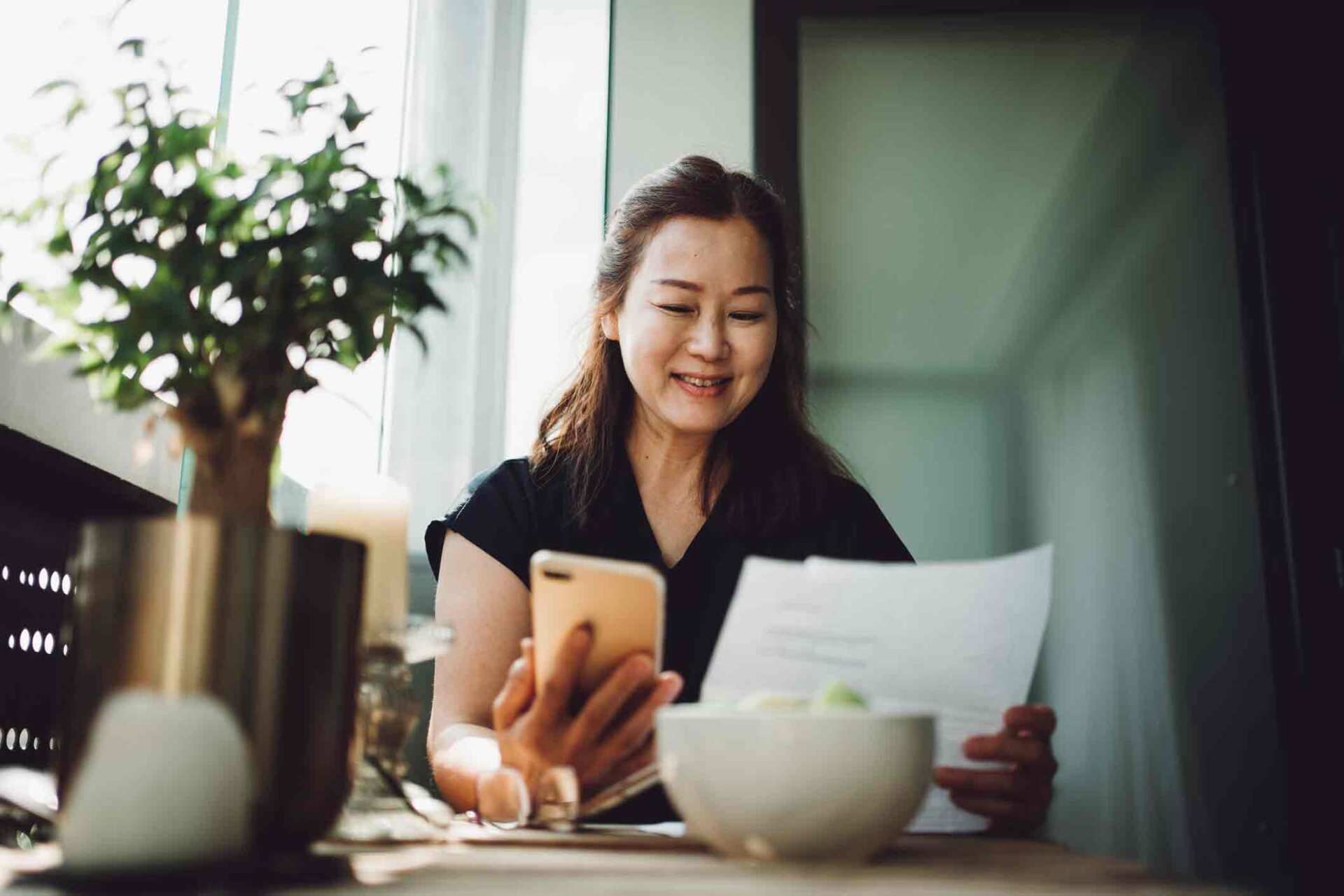 Asian Women Checking Documents — Forest City, NC — Green Insurance