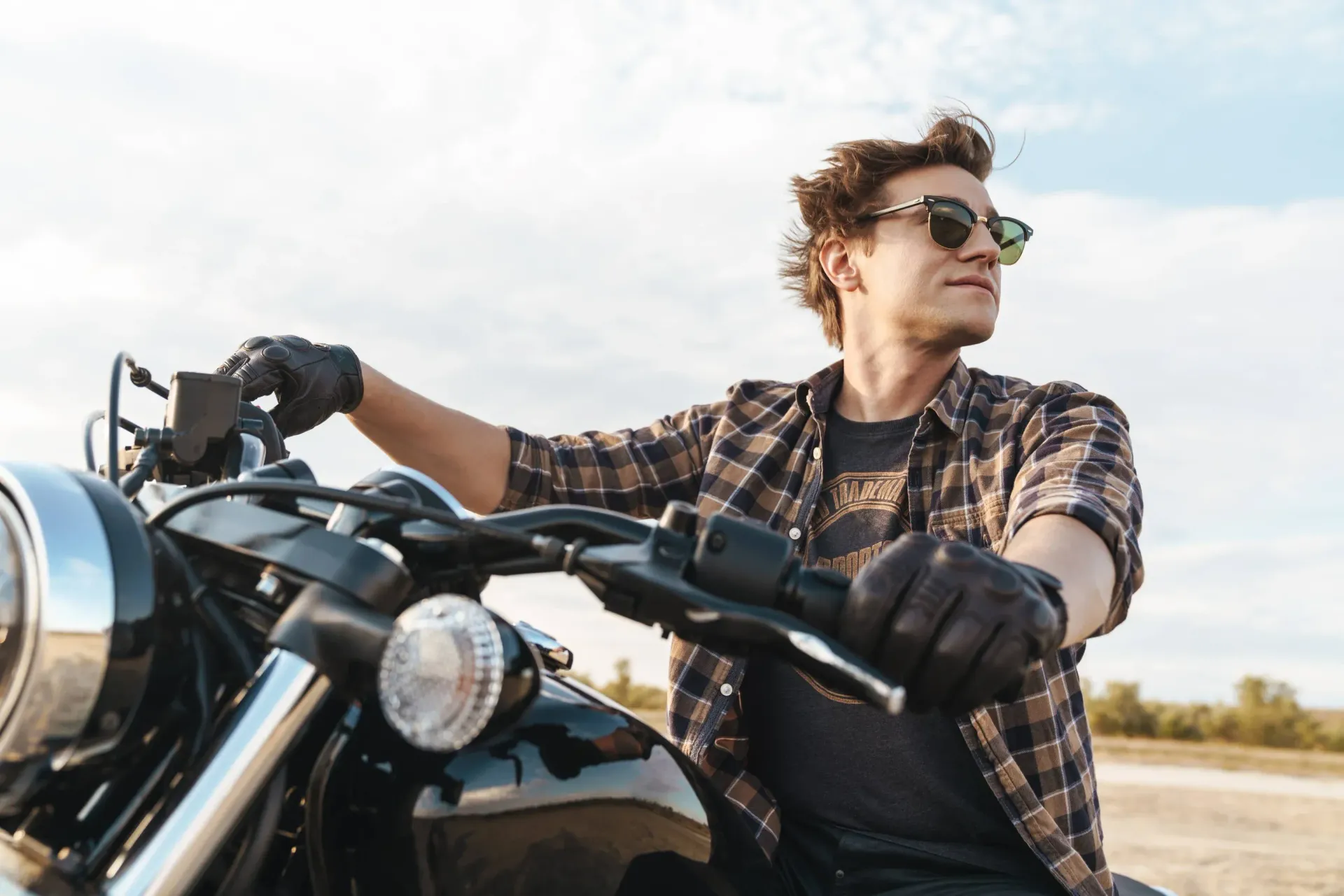 Man on a motorcycle wearing sunglasses.