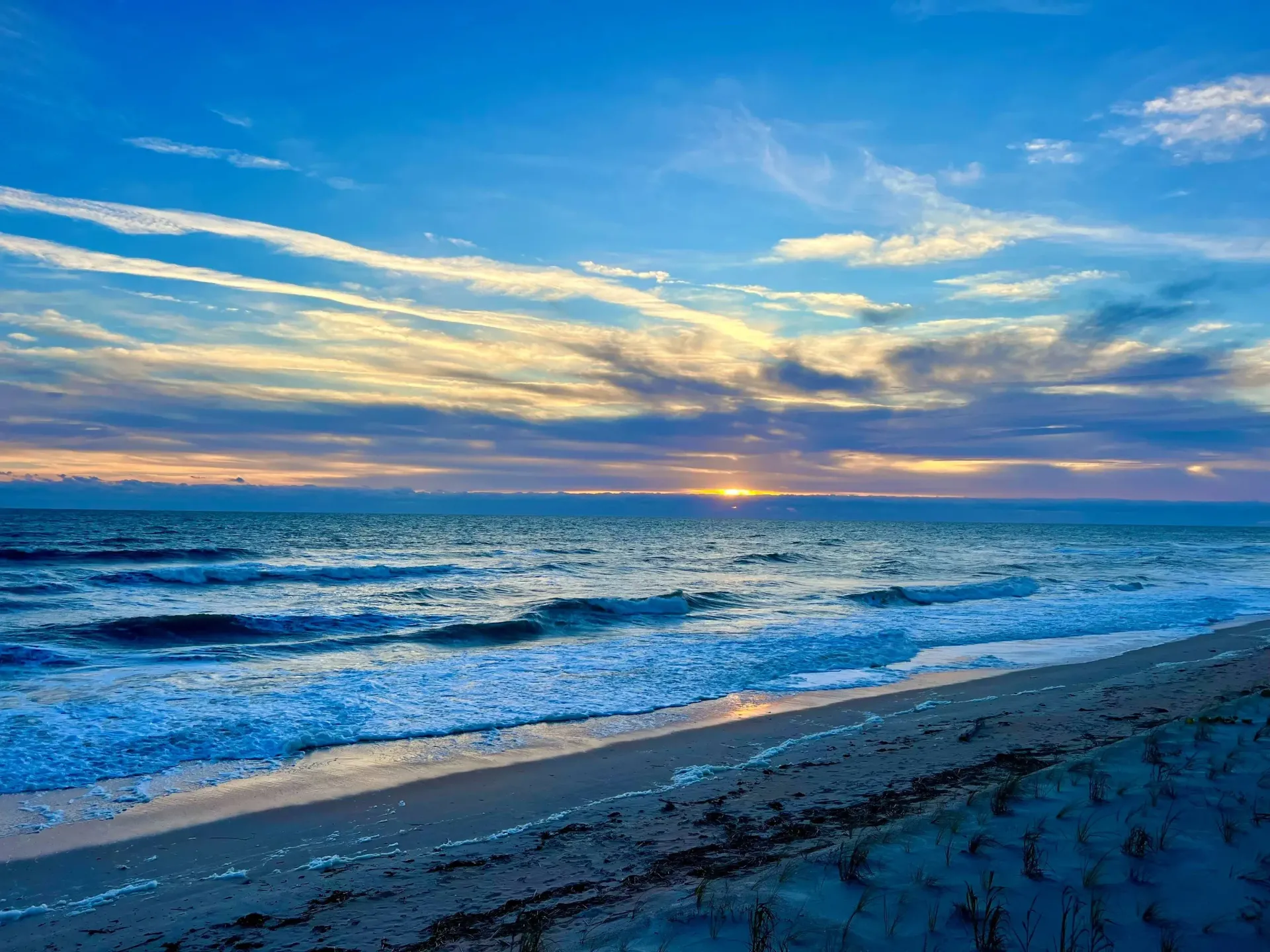 Beautiful blues coloring the sky and beach just after sunset.