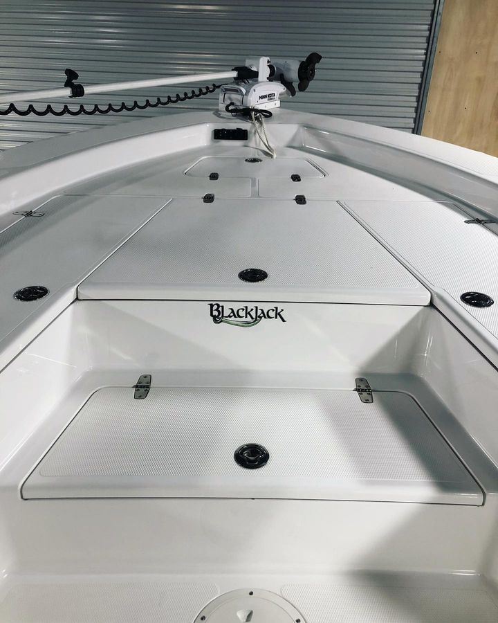 White Blackjack boat deck with storage compartments.