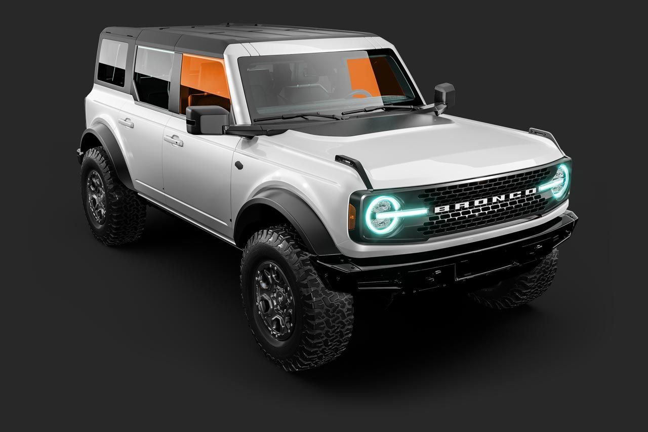 White Ford Bronco SUV, black accents, on a dark surface.