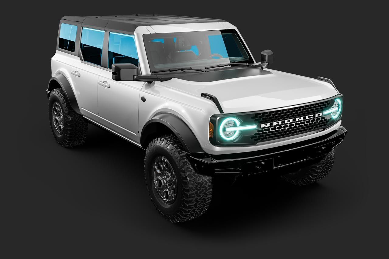 White Ford Bronco SUV with black accents, tinted windows, and off-road tires on a dark gray background.